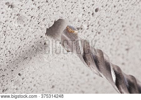Metal Drill Bit Make Holes In Concrete Wall On Industrial Drilling Machine With Shavings. Metal Work
