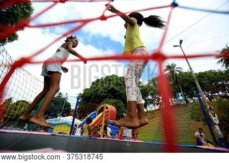 Salvador, Bahia / Brazil - February 21, 2016: Children Are Seen Playing On The Pogo Stick In The Dik