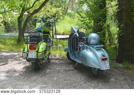 Villaggio Di Punta Sdobba, Italy - June 14 2020. Two Vespas, Part Of A Small Rally Of Vespa Motorike