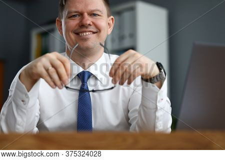 Man Business Clothes Sitting At Table And Smiling. Happy Man Working At Home In Self-isolation. Impl