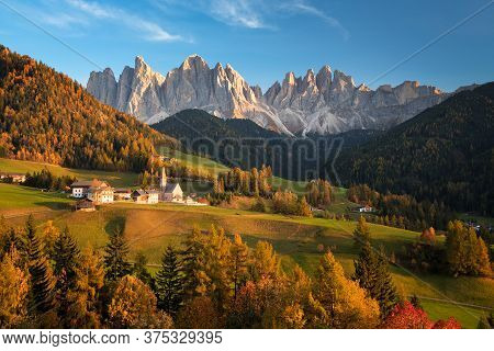 Church In The Tiny Village Sankt Magdalena In Villnoess In An Autumn Landscape With Yellow Larch Tre