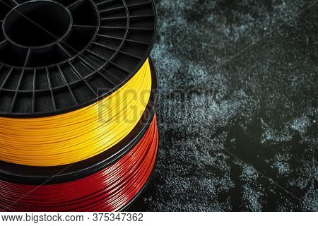 Filament For 3d Printing. Bright Thermoplastic Of Neon Yellow And Red Colors. Reel Horizontal View. 