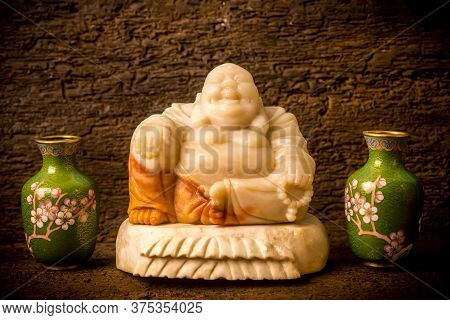 Spiritual Figurine Budai Maitreya Between Ornamental Green Vases On Dark Ground Shelf