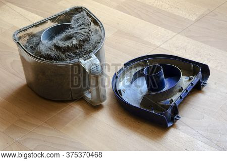 Vacuum Cleaner Container With Garbage. A Plastic Waste Container Full Of Dust And Wool. Cleaning Ser