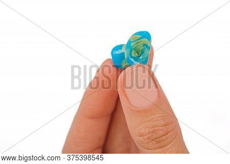 Isolated On White Earplug In Female Hand. Personally Molded Earplugs Close-up. Part Of The Set