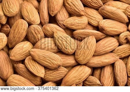 Top View Of Badam, Almonds Textured Background.
