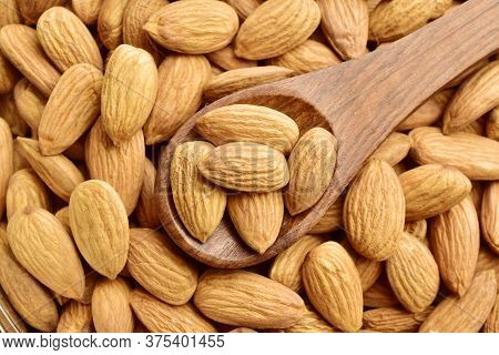Almonds In Wooden Spoon, Top View Of Badam.