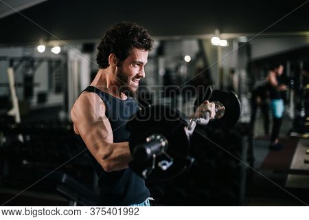 Side View Of Sportive Bearded Young Man With Muscular Wiry Body Wearing Sportswear Working Out With 