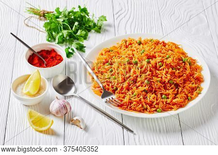 Close-up Of Tomato Onion Green Peas Rice Pilaf, Tamatar Biryani On A White Plate On A White Wooden T