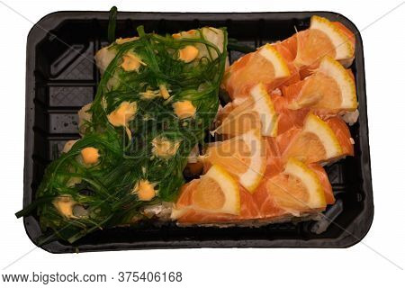 Seafood Rolls Are In A Disposable Container On A White Background In Isolation