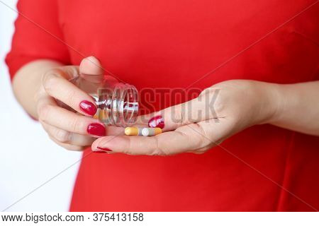 Woman In Red Dress With Pills In Hands. Girl Holding Bottle With Capsules, Concept Of Pharmacy, Vita