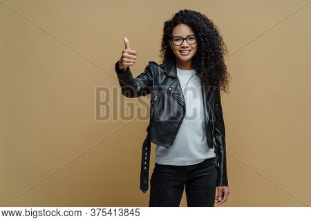 Confident Cheerful African American Woman Shows Thumb Up In Approval, Gives Recommendation Or Advice