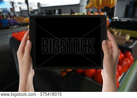 Wholesale Trading. Woman Using Wms App On Tablet At Market, Closeup