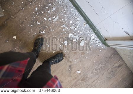 Apartment Interior Renovation. Old Wallpaper Partially Scraped Off. Dirty Torn Wallpaper On The Floo