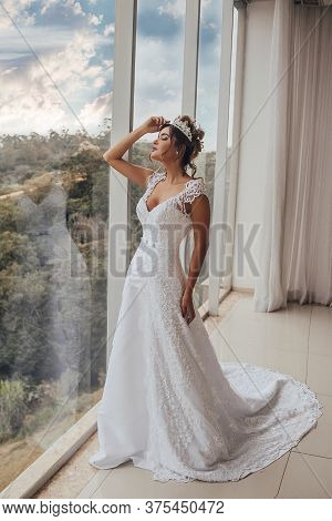 Beautiful Bride In Her Wedding Dress Posing For Photos.