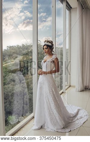 Beautiful Bride In Her Wedding Dress Posing For Photos.