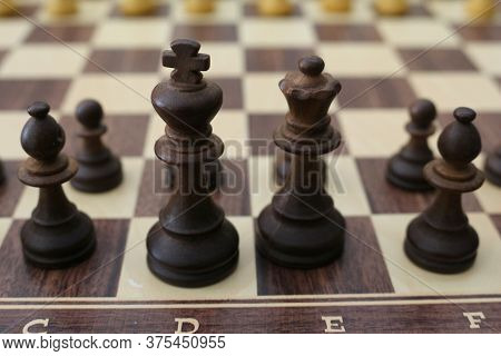 Chess Pieces On The Board. Wooden Chess Pieces On The Chessboard.