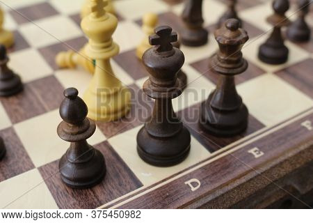 Chess Pieces On The Board. Wooden Chess Pieces On The Chessboard.