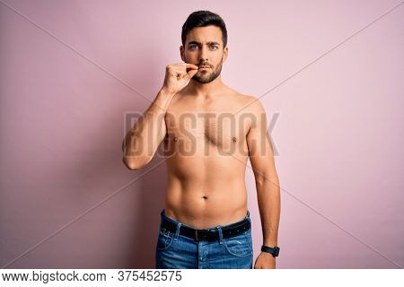 Young handsome strong man with beard shirtless standing over isolated pink background mouth and lips shut as zip with fingers. Secret and silent, taboo talking