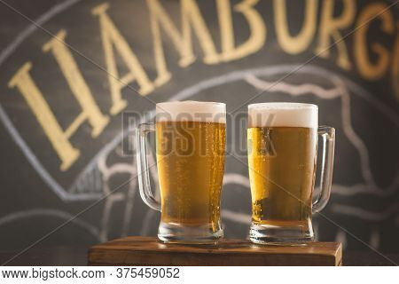 Two Mugs Of Chopp On The Table