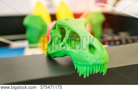 3D printer printing dragon head figure close-up.