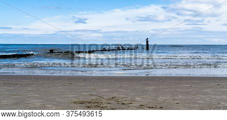 Baltic Sea Beach In Bansin Usedom With Seagulls Standing On Breakwater