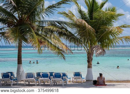 Tourists On The Mahahual Sandy Beach, Quintana Roo, Mexico