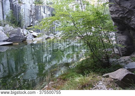 Small Natural Lake Inside A Marble Quarry In Mountain In Apuan Alps