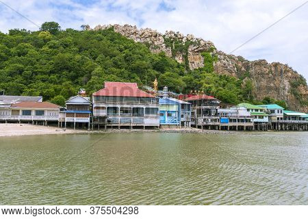 Seaside Village With Mountains Behind At Khao Sam Muk In Chon Buri Province.