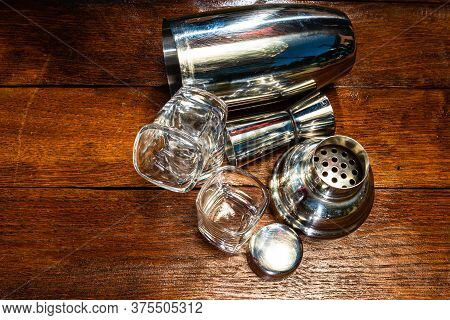 Bar Ustensils, Drink Concept. Cocktail Shaker Accessories On A Wooden Board.