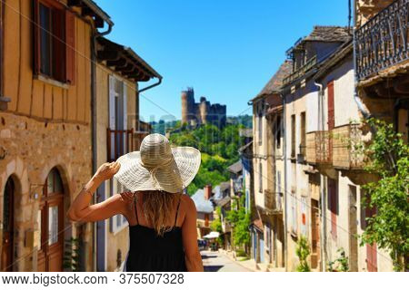 woman tourist in medieval french village- Najac