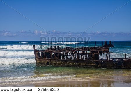 Photograph Of The Shipwreck Of The Ss Maheno On Fraser Island With A Cloudless Sky In The Background