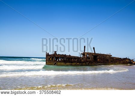 Photograph Of The Shipwreck Of The Ss Maheno On Fraser Island With A Cloudless Sky In The Background