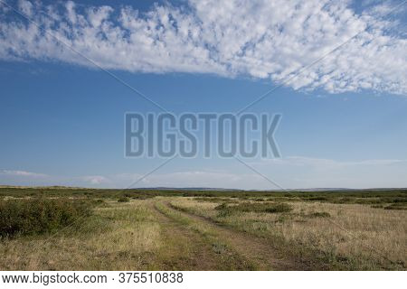 Country Road On A Vast Plain In The Summer.