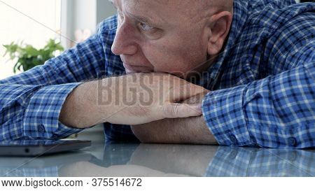 Sad Elderly Person Isolated In Quarantine At Home Looking Bored And Disappointed To A Cell Phone
