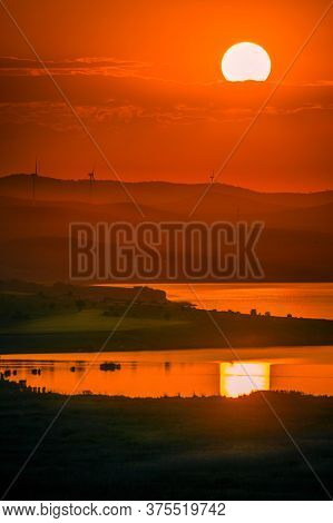 Eolian Wind Turbines Placed On Hills Used To Produce Ecological Green Electricity Shot At Sunset Wit