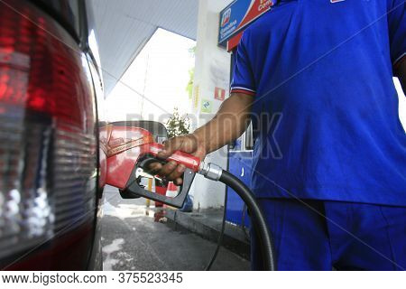 Salvador, Bahia / Brazil - December 6, 2016: Gas Station Attendant Supplies Gasoline At Gas Stations