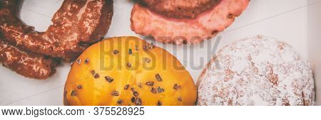 Donuts box panorama banner. Boston cream passion fruit doughnut, berry jelly filled berliner, glazed cruller fried donut pastry. Cake donut header background.