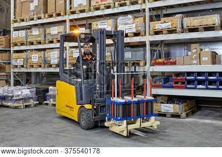 St. Petersburg, Russia - December 24, 2018: Industrial Warehouse With Shelving System. A Forklift Tr