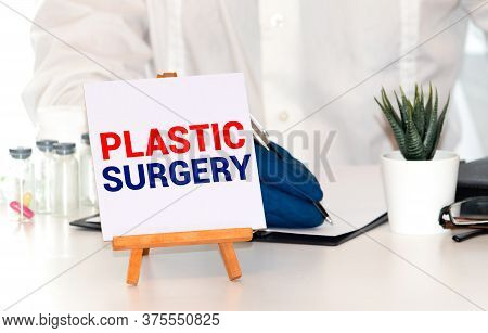 Plastic Surgery Concept Written On A Card In Doctors Hands