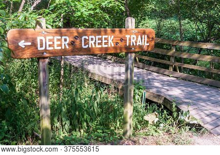 The Deer Creek Trail Sign In Frick Park, Pittsburgh, Pennsylvania, Usa On A Sunny Summer Day