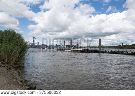 Temse, Belgium, 05 July 2020, Turbulent Water Of The Scheldt With The Last Crane Van Boelwerf In The
