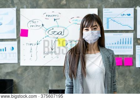 Portrait Of Young Asian Woman Worker Wear Medical Mask Protection Looking At Camera Smiling Under Su