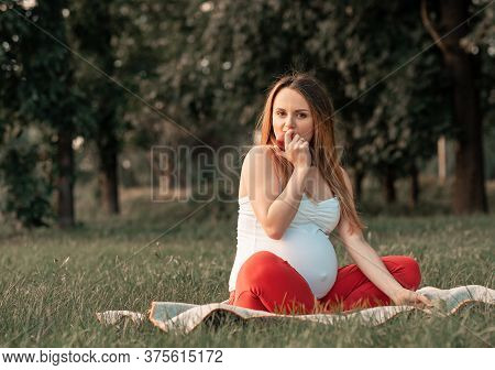 Cute Pregnant Woman Eat Apples On Picnik. Healthy Pregnancy, Pregnant Young Female In Park Summer