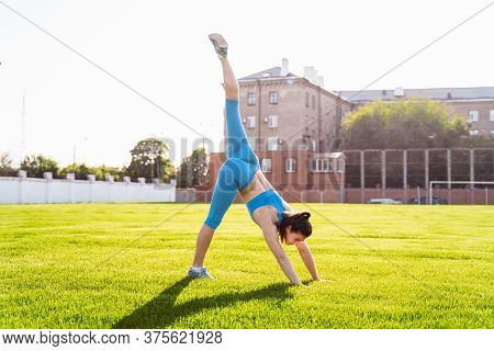 Incredibly Beautiful, Athletic Girl Does Exercises At The Sports City Stadium On A Warm Summer Eveni