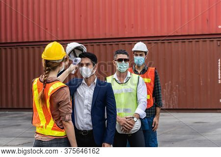 Engineer Worker Wearing Surgical Mask Checking Body Temperature Using Infrared Digital Thermometer C