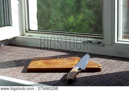 Knife And Cutting Board With Crumbs On The Windowsill, Creative Still Life With Hard Light, Empty An