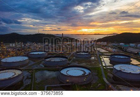 Aerial View Of Oil Refinery Plant Chemical Factory And Power Plant With Many Storage Tanks And Pipel