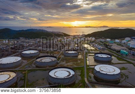 Aerial View Of Oil Refinery Plant Chemical Factory And Power Plant With Many Storage Tanks And Pipel