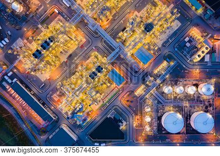 Aerial View Of Oil Refinery Plant Chemical Factory And Power Plant With Many Storage Tanks And Pipel